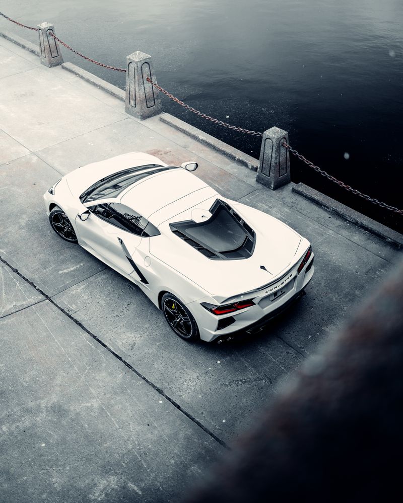 Overhead shot of a white Corvette by the water